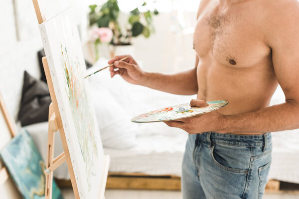 cropped view of sexy shirtless man drawing with brush and holding palette