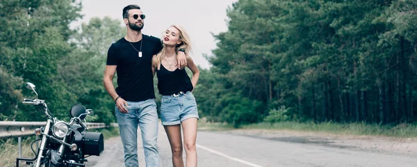 Young Attractive Couple Bikers Walking Road Embracing Black Motorcycle Panoramic — Stock Photo, Image