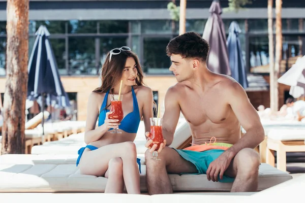 Smiling Young Couple Sitting Deck Chair Glasses Refreshing Drink Looking — Stock Photo, Image