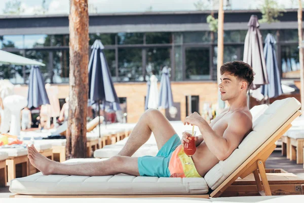 Handsome Young Man Looking Away While Relaxing Deck Chair Glass — Stock Photo, Image
