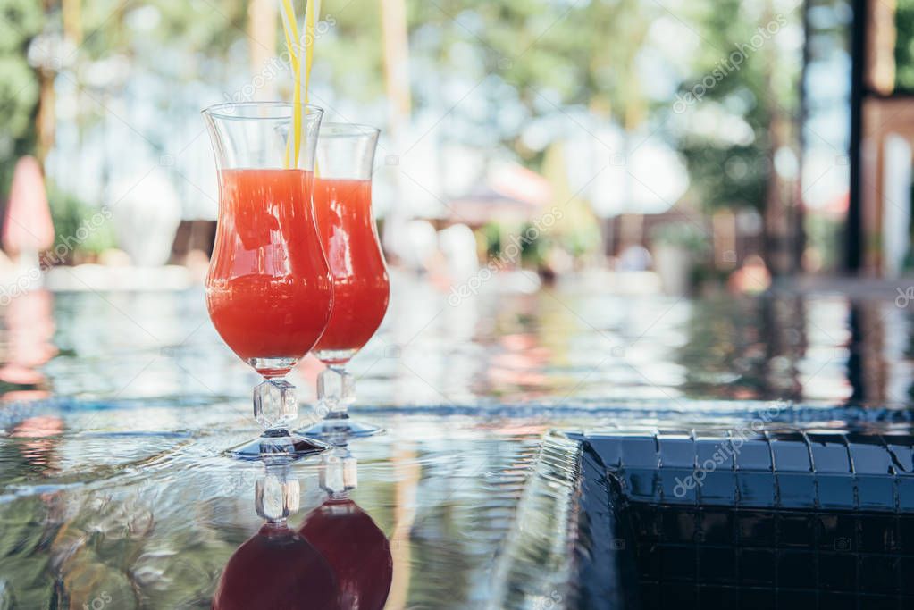 two glasses with natural, delicious refreshing beverage at poolside