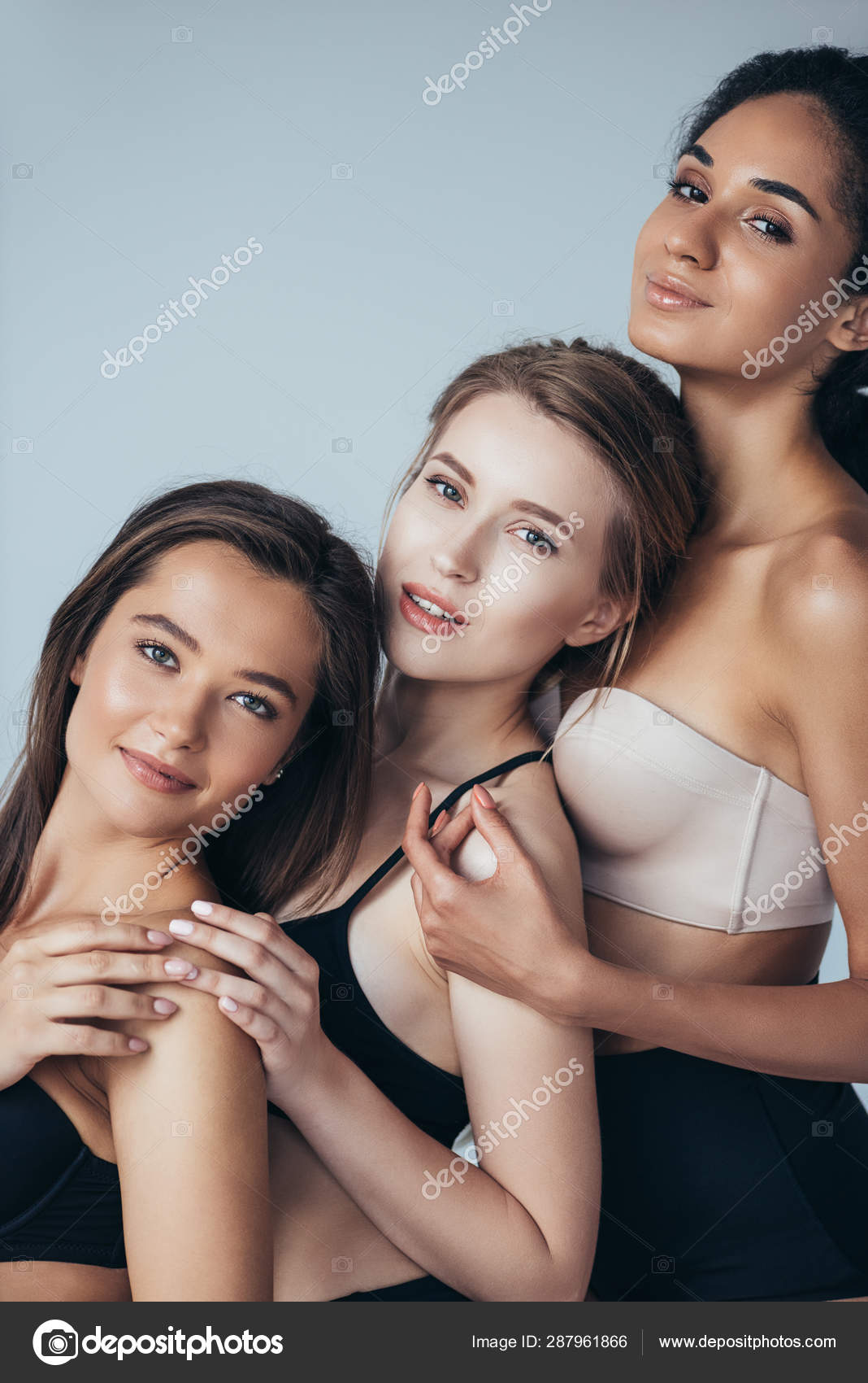 Three Sexy Multiethnic Girls Underwear Embracing Smiling Isolated Grey  Stock Photo by ©VitalikRadko 287961866