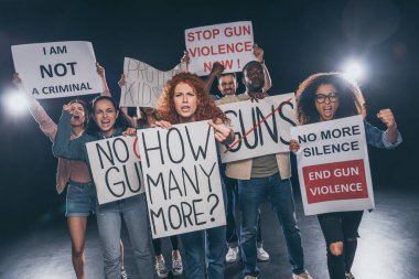 emotional multicultural people holding placards with letters on black  clipart