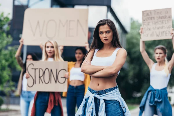 Serious Feminist Standing Arms Closed Women Holding Placards Feminist Slogans — Stock Photo, Image