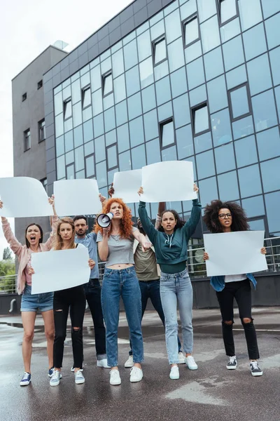 angry multicultural group of people holding empty placards