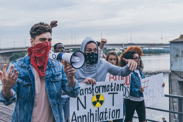 избирательный фокус эмоциональных мультикультурных людей с надписью на плакатах, выходящих на улицу
 