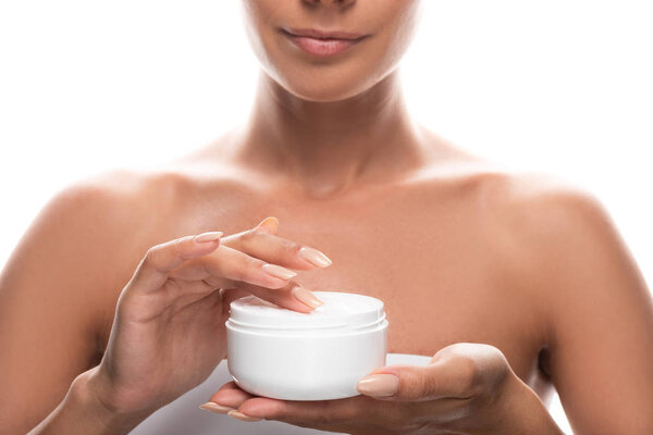 cropped view of young woman holding cosmetic cream isolated on white