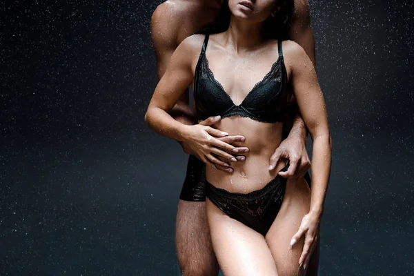 Cropped View Muscular Man Hugging Young Wet Woman Raindrops Black — Stock Photo, Image