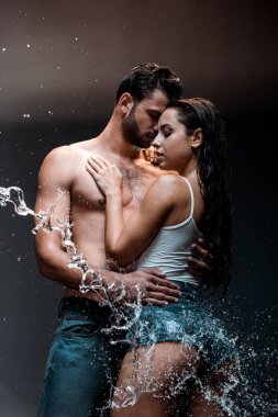 yakışıklı ve gömleksiz adam siyah su sıçrama sıyrık yakın kız arkadaşı kucaklayan 