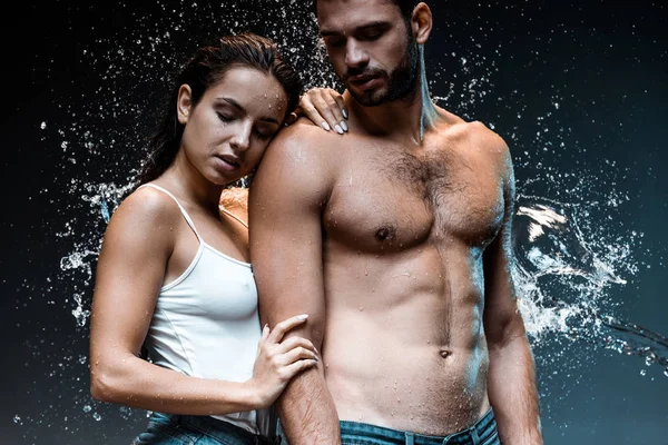 Shirtless Man Standing Attractive Woman Splash Water Black — Stock Photo, Image