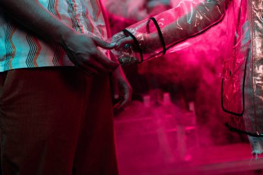 Gece kulübünde adama plastik fermuarlı poşet içinde tavuk veren kadının Kırpılmış görünümü