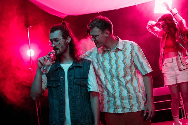 Man Hugging Another Man Drinking Water Nightclub Rave Party — Stock Photo, Image