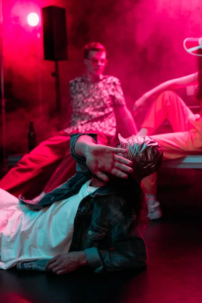 Selective Focus Man Lying Floor Nightclub Covering Face — Stock Photo, Image