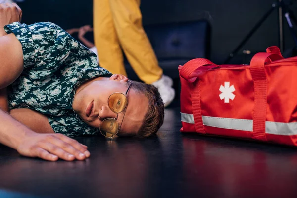 Man Sunglasses Lying Floor First Aid Kit Bag Nightclub — Stock Photo, Image