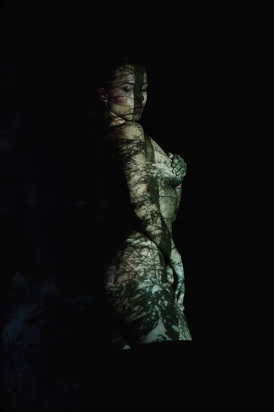 美丽的脱衣服的年轻女子与阴影在身体上站在黑色 — 图库照片