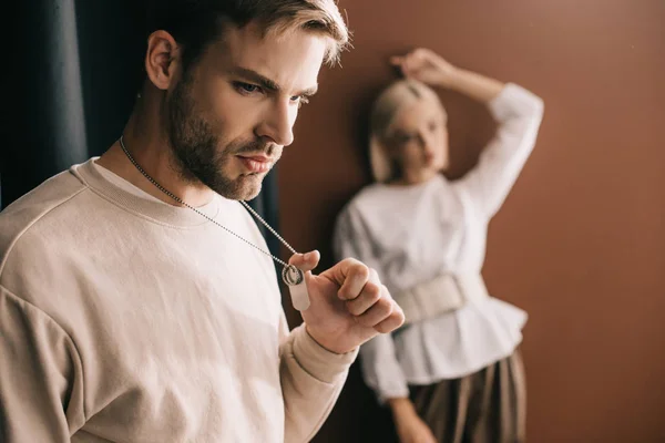 Pensive Young Man Touching Pendants Blonde Girl Brown — Stock Photo, Image