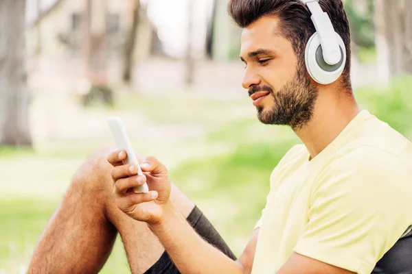 Happy Skäggiga Man Lyssnar Musik Och Använder Smartphone — Stockfoto