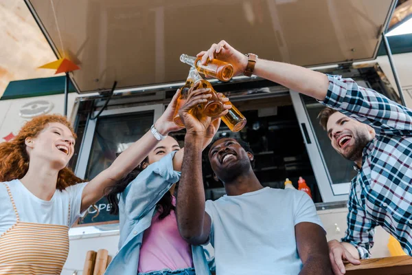 Low Angle View Cheerful Multicultural Friends Clinking Bottles Beer Food — Stock Photo, Image