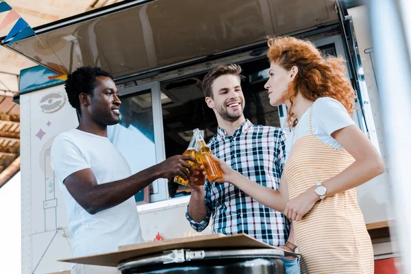 Bajo Ángulo Vista Feliz Multicultural Hombres Tintineo Botellas Cerveza Con — Foto de Stock