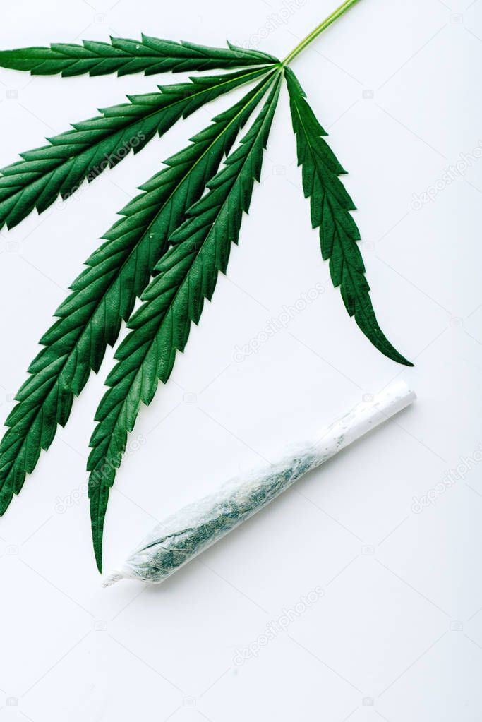 top view of blunt and marijuana on white background 