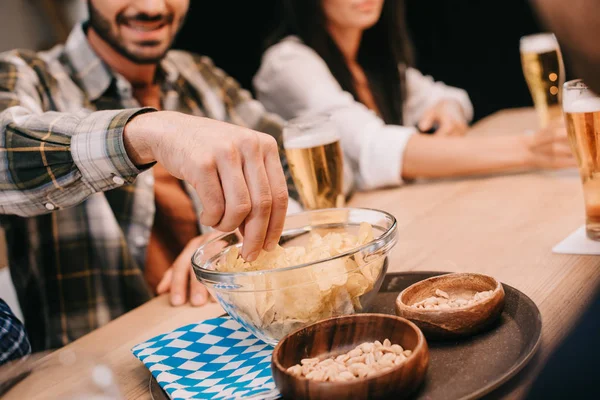 Cropped View Man Taking Chips Bowl While Sitting Friends Pub — Stock Photo, Image
