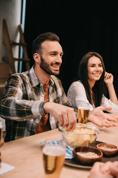 Selektiv Fokusering Ung Man Tar Chips Från Bowl När Sitter — Stockfoto