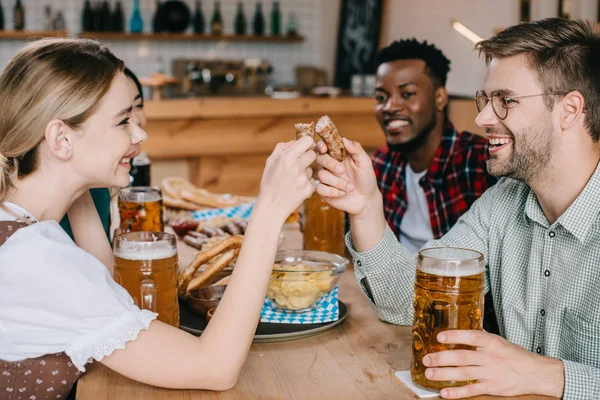 Young Woman Woman Holding Fried Sausage While Celebrating Octoberfest Friends — Stock Photo, Image