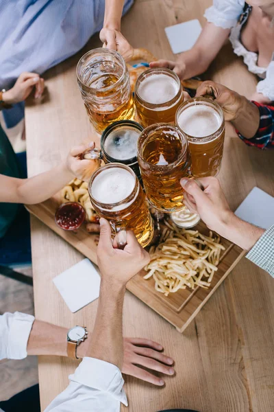 Cropped View Multicultural Friends Clinking Mugs Light Dark Beer — Stock Photo, Image