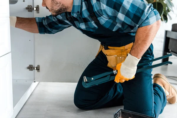 Cropped View Bearded Repairman Holding Wire Cutters Kitchen Cabinet — Stock Photo, Image