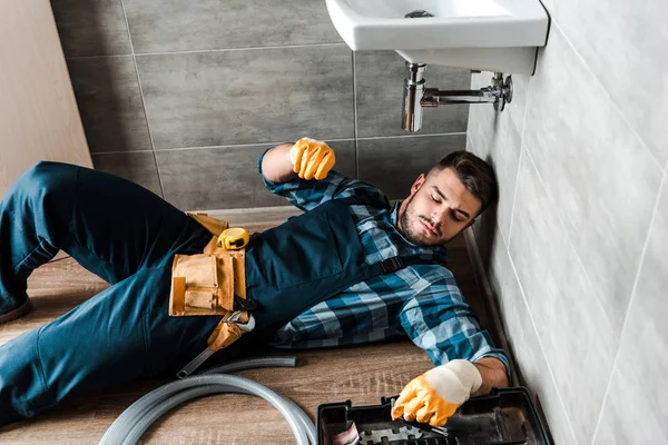 Bearded Handyman Lying Floor Toolbox Bathroom — Stock Photo, Image
