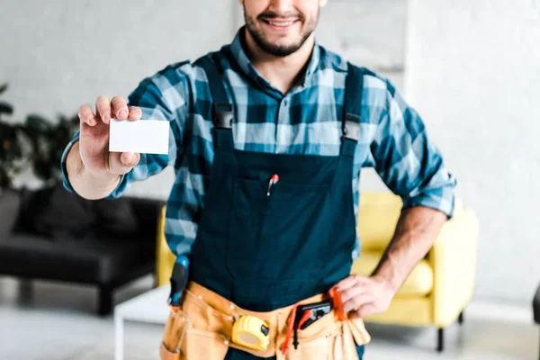 Vista Cortada Trabalhador Alegre Segurando Cartão Branco Com Mão Quadril — Fotografia de Stock