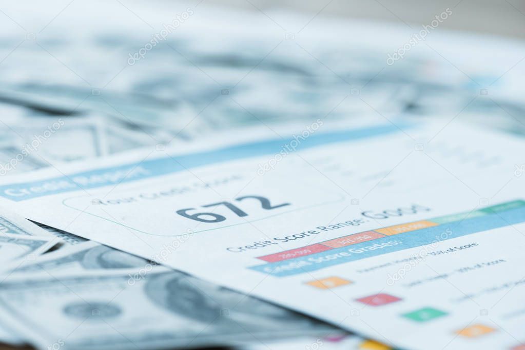 selective focus of paper with credit score lettering on dollar banknotes 