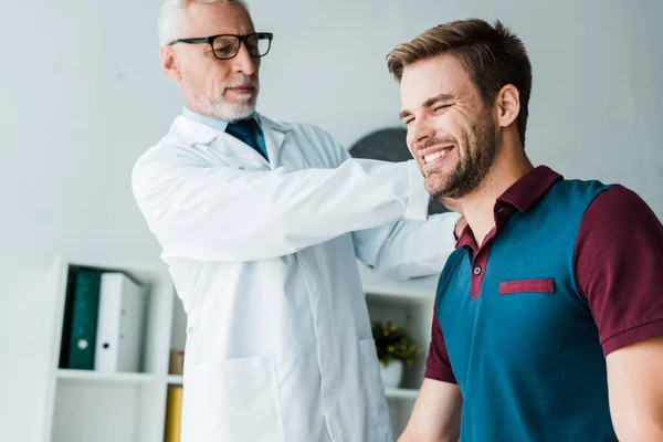 Chiropractor White Coat Glasses Touching Happy Patient Clinic — Stock Photo, Image