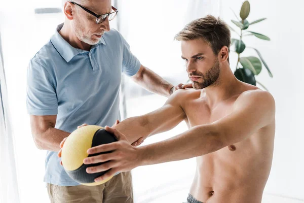 Bearded Doctor Glasses Looking Shirtless Patient Working Out Ball — Stock Photo, Image