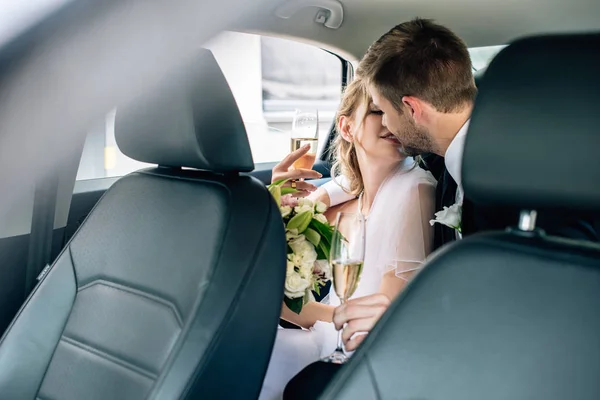 Attractive Bride Handsome Bridegroom Kissing Holding Champagne Glasses — Stock Photo, Image