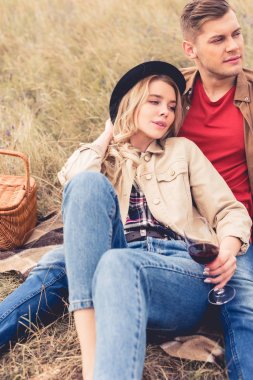 yakışıklı adam uzağa bakıyor ve şarap bardağı tutan çekici kadın