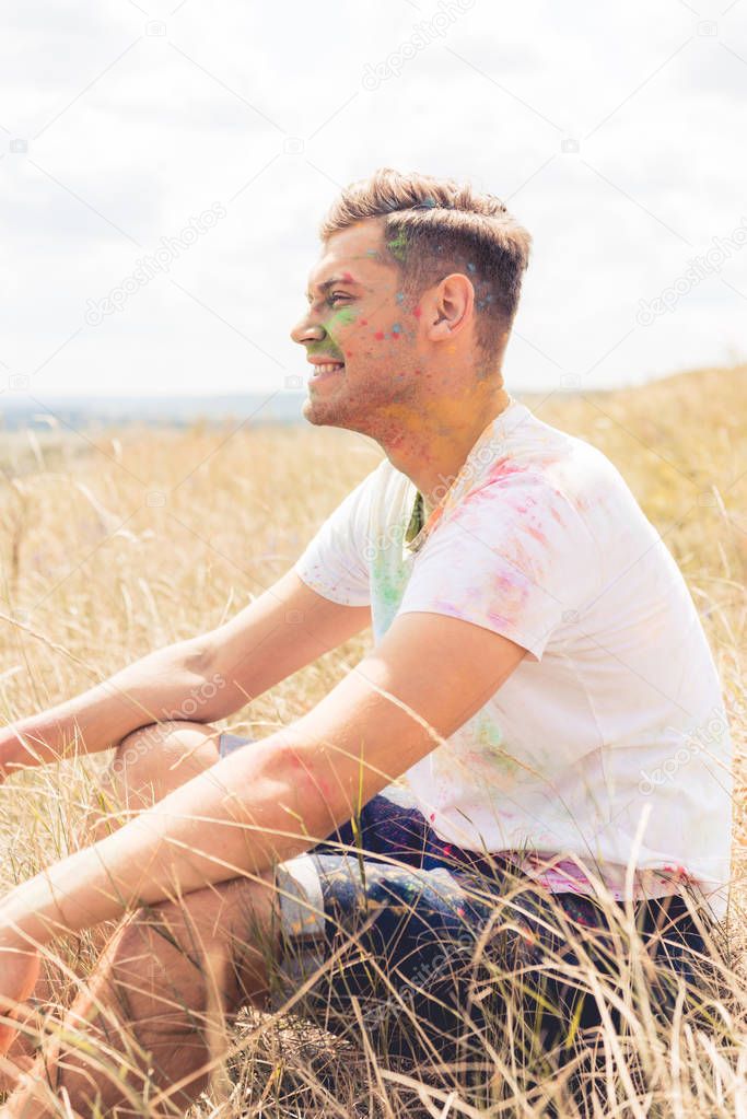 side view of handsome man in t-shirt smiling and looking away 