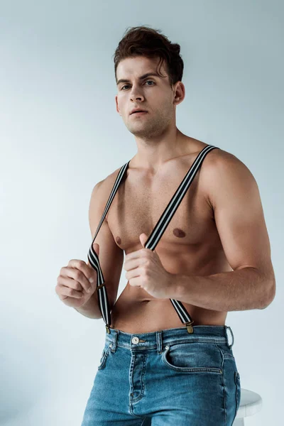 Muscular Man Touching Suspenders Looking Camera White — Stock Photo, Image