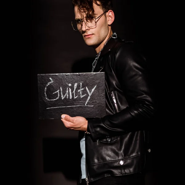 Handsome Man Holding Chalk Board Guilty Lettering Black — Stock Photo, Image