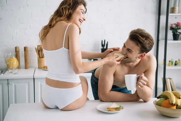 Back View Girlfriend Feeding Sandwich Handsome Boyfriend Apartment — Stock Photo, Image