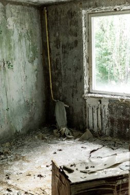 selective focus of damaged and dirty room in empty home in chernobyl  clipart