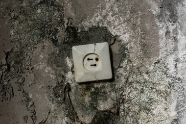 rusty power socket in damaged grey wall  clipart