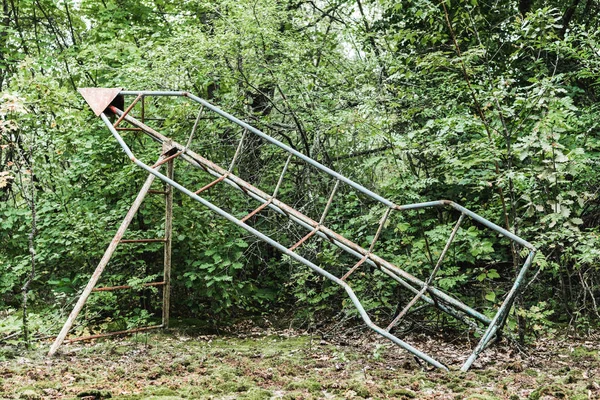 绿色公园中废弃的金属结构 — 图库照片