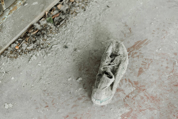 top view of abandoned and dirty shoe on floor 