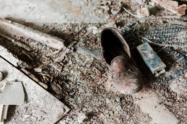 abandoned and dirty shoe on floor in chernobyl 