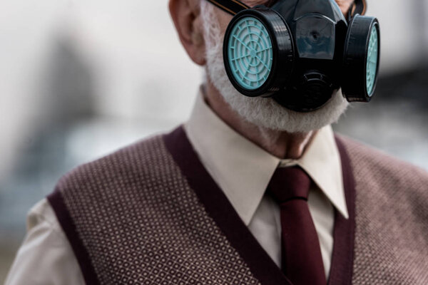 cropped view of senior man in protective mask in chernobyl 