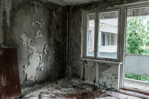 damaged and dirty room with flaky walls in chernobyl 