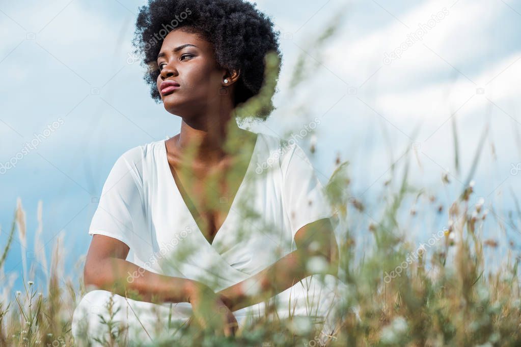 selective focus of attractive african american woman in white dress 