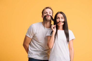 funny couple in white t-shirts making mustache from hair, isolated on yellow clipart