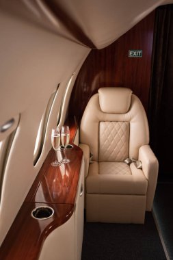 empty aircraft with glasses of champagne for trip clipart